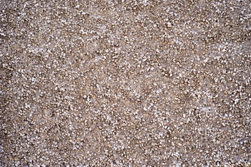 Texture of a part of the wall made of concrete with stone chips.