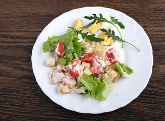 caesar salad in oak plate