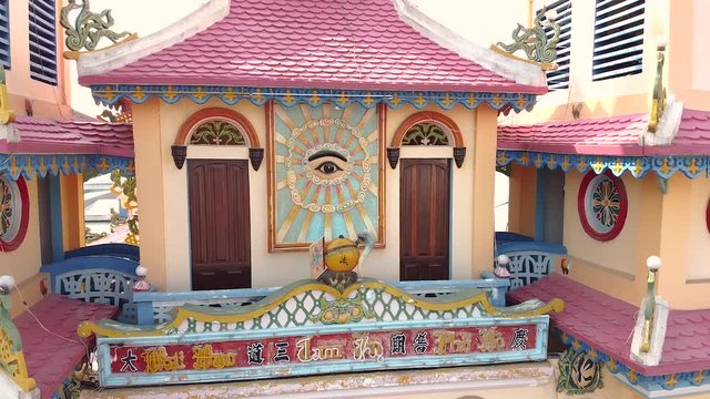 Aerial drone footage along the dront towers of a Cao Dai church in Cai Be city, Mekong Delta, Vietnam. Footage slide from right to the left.