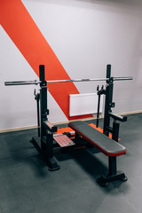 Fototapeta premium Modern light gym. Sports equipment in gym. Barbells of different weight on rack.