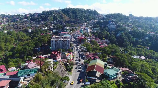 Pull Out Slow Motion Aerial Shot Of Traffic On Top Of Mountains In Baguio Philippines