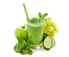 Freshly blended green fruit smoothie in glass, healthy detox vitamin diet food concept. Raw vitamins breakfast smoothie drink. Greens, spinach, apple, cucumber for smoothie isolated on white.