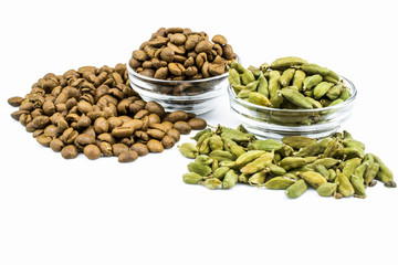 Glass bowls with cardamom and coffee isolated on a white background.