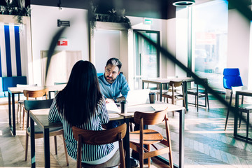 Concentrated staff communicating in canteen