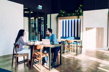 Friendly partners communicating at workplace