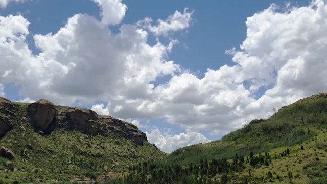 Moluti sandstone cliffs at the border of Lesotho in South Africa at the Camelroc travel guest farm, stunning cloud time lapse, most amazing mountains and green scenery landscapes