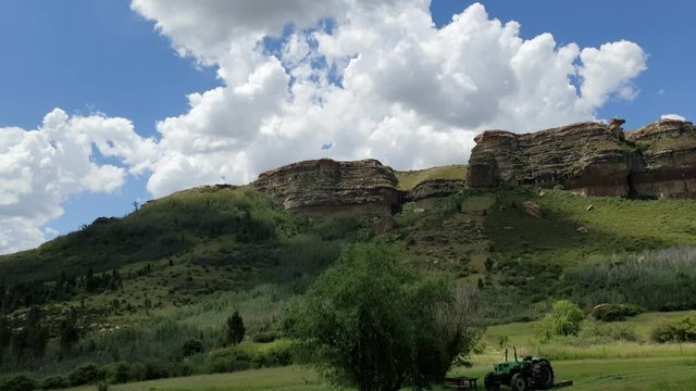 Moluti sandstone cliffs at the border of Lesotho in South Africa at the Camelroc travel guest farm, stunning cloud time lapse, most amazing mountains and green scenery landscapes
