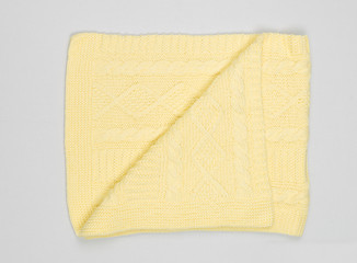 handmade wool yellow scarf on vertical image, selective focus.