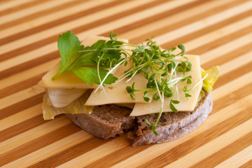 Sandwich with cheese and fresh sprouts of garden cress