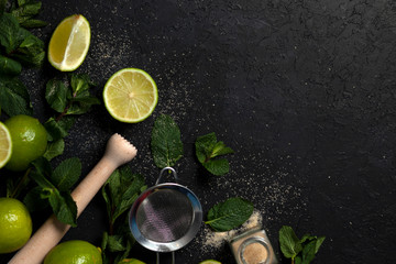 ingredients for making mojito on a dark background, lime, mint, with tools, flat lay for a mojito...