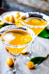 cocktail with kumquat on wooden background