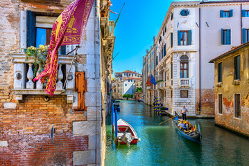 Narrow canal with gondola and bridge in Venice, Italy. Architecture and landmark of Venice. Cozy cityscape of Venice. © Ekaterina Belova