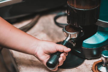 Barista prepares American coffee for brewing in the coffee shop.