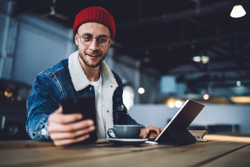 Interested young man browsing in smartphone