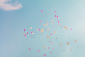 Heart love balloons fly into turquoise sky with ceremony wishes. Romantic symbol of future partnership. Group of beautiful heart ballons with congratulations cards at wedding party or valentines day