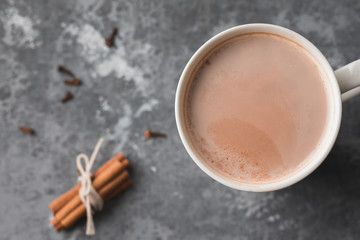 A white cup of hot cocoa drink with cinnamon