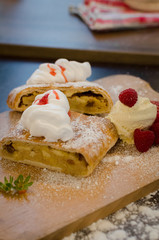 Vertical view of ready to eat apple cake with cream - Stock image