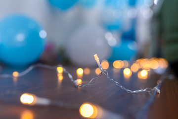 Decoration lights with confetti from a party littered around. selective focus