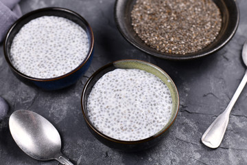 Chia seed pudding made with dry seeds soaked in milk in small bows