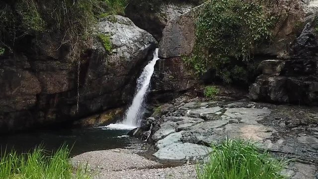Slow Motion Aerial View of Las Garzas Waterfall, Adjuntas, Puerto Rico, Freshwater Creek Water Falling in Pond