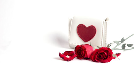 Heart shaped bag and red rose on a white background.