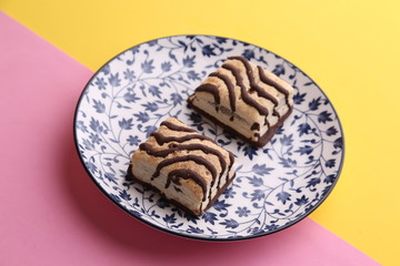 small chocolate cakes in color background