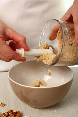 Making filling, process walnuts and icing sugar in food processor. Making Chocolate Hazelnut Meringue Cake.