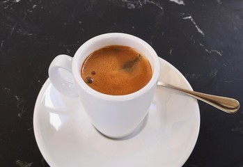 Obraz na płótnie Canvas White cup of hot coffee on table photo isolate on black 