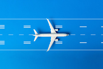 Take-off airplane on runway on blue background. Travel Planning. Preparation for Summer Traveling