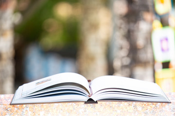 Open book with blurred background.