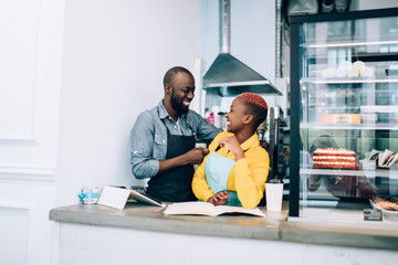 Black waitress having fun with barista during work