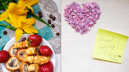 strawberry, cookie hearts with a Cup of black coffee beans, with yellow flowers and a note Good morning happy Valentine's day