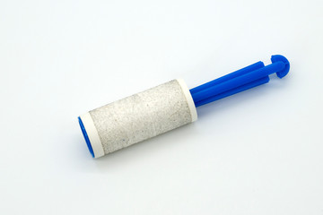 A roller for cleaning clothes lies on a white background