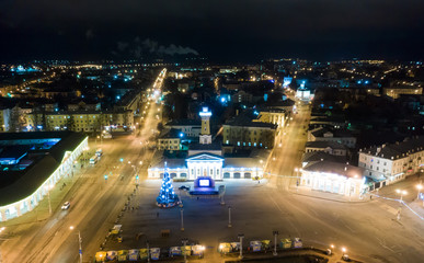 Night view of city center Kostroma with car traffic and illuminated Fire tower, Russia.