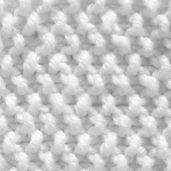 Handmade knitting texture, white background. Gray wool with fine threads, close-up.