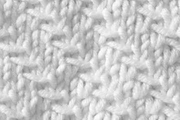 Handmade knitting texture, white background. Gray wool with fine threads, close-up.