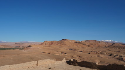 Bright landscape of Morocco, breathtaking curves of mountains, stunning combination of hills & farm land,inadvertent distribution of houses & huts, raw impression of pure nature.