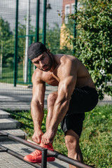 A fitness athlete trains on a sports field. Healthy lifestyle