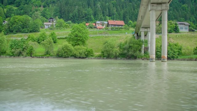 View from a boat sailing along Drava River and passing under a bridge in Slovenia