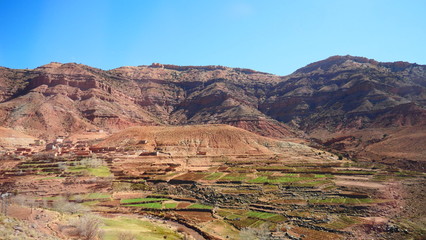 Bright landscape of Morocco, breathtaking curves of mountains, stunning combination of hills & farm land,inadvertent distribution of houses & huts, raw impression of pure nature.