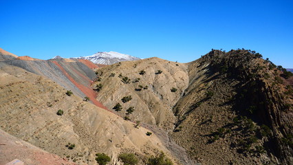 Bright landscape of Morocco, breathtaking curves of mountains, stunning combination of hills & farm land,inadvertent distribution of houses & huts, raw impression of pure nature.