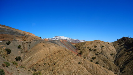 Bright landscape of Morocco, breathtaking curves of mountains, stunning combination of hills & farm land,inadvertent distribution of houses & huts, raw impression of pure nature.