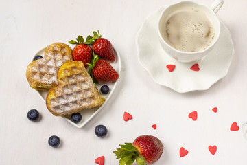 Waffle biscuits in shape of heart on rustic background for Valentines day