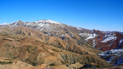Fototapeta premium Bright landscape of Morocco, breathtaking curves of mountains, stunning combination of hills & farm land,inadvertent distribution of houses & huts, raw impression of pure nature.