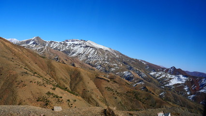 Bright landscape of Morocco, breathtaking curves of mountains, stunning combination of hills & farm land,inadvertent distribution of houses & huts, raw impression of pure nature.