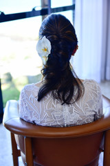 bride sitting on her back with flowers in her hair, hairstyle, women's hairstyle, bridal hairstyle,...