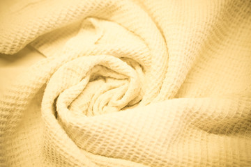 Kitchen towel with textured surface. Croissants bends on a cotton fabric with a square patterned texture.