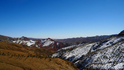 Bright landscape of Morocco, breathtaking curves of mountains, stunning combination of hills & farm land,inadvertent distribution of houses & huts, raw impression of pure nature.