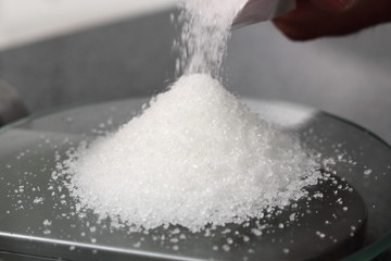 Weighing sugar on kitchen scale. Making Golden Syrup Series.