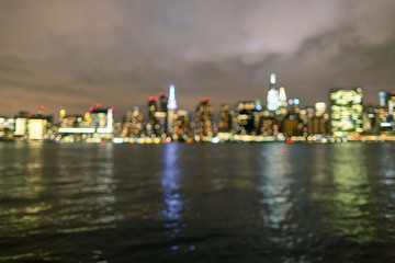 Fototapeta premium Blurred midtown Manhattan at night From East river